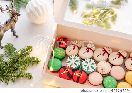 Variety of sweet macaroons in white box. Modern european French cuisine. Christmas theme, Merry Variety of sweet macaroons in white box. Modern european French cuisine. Christmas theme, Merry 46129729