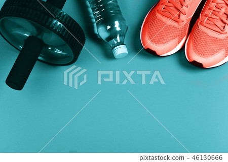 Living Coral sneakers on blue background. Living Coral sneakers on blue background. 46130666