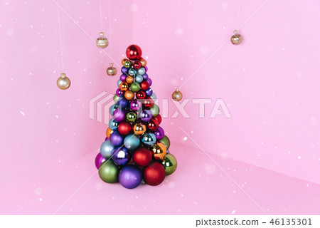 Christmas tree made of ball decoration on pink background. Christmas tree made of ball decoration on pink background. 46135301