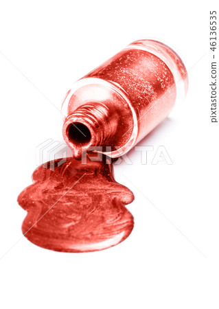 Trendy living coral color nail polish isolated on white background. Trendy living coral color nail polish isolated on white background. 46136535