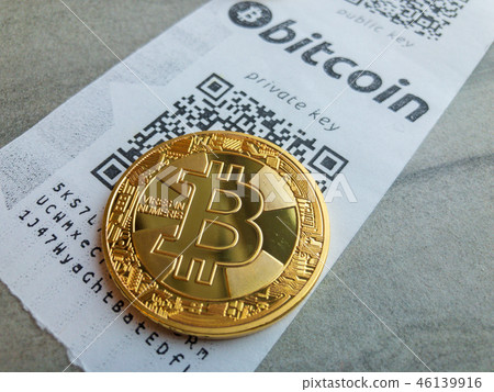Golden bitcoin coin lying on the receipt 46139916