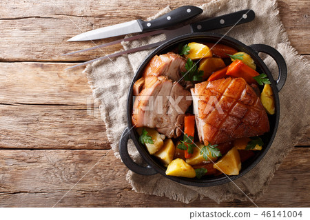 Tasty crispy pork baked in beer with vegetables 46141004