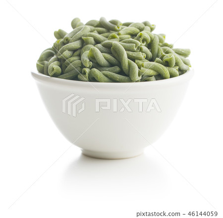 Uncooked spinach gemelli pasta. 46144059