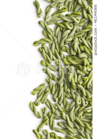 Uncooked spinach gemelli pasta. 46144066