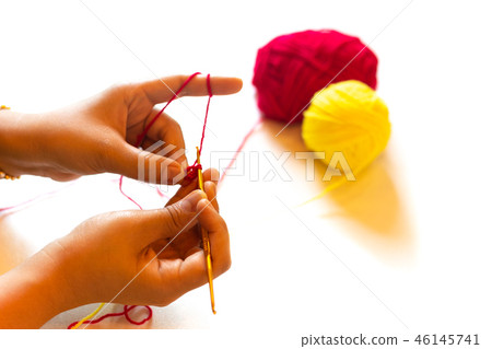 Female hand knitting crochet isolated in white background. Female hand knitting crochet isolated in white background. 46145741
