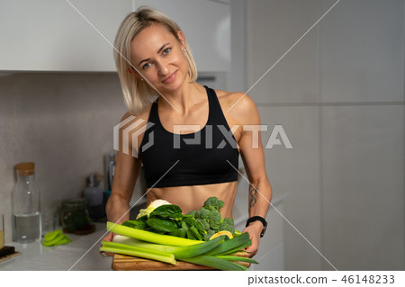 a sporty girl with set of green vegetables 46148233