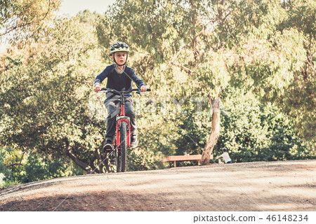 Boy riding his bicycle 46148234