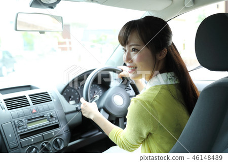 A woman driving a car 46148489