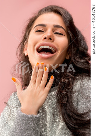 Beautiful young woman with teeth braces 46148768