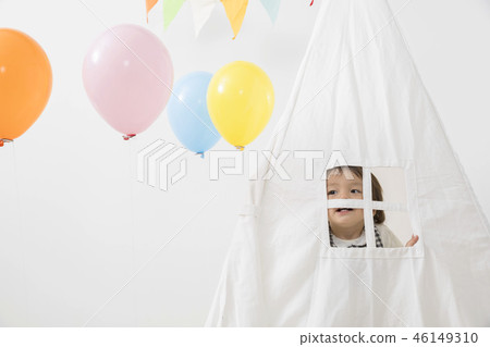 Infant boy playing in an indoor tent 46149310