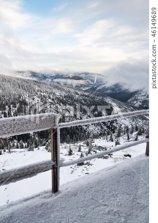 Big hoarfrost on railing snowy mountains landscape 46149689