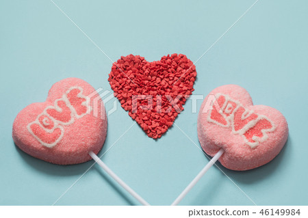 Couple valentine pink lollipops on pastel blue.  46149984