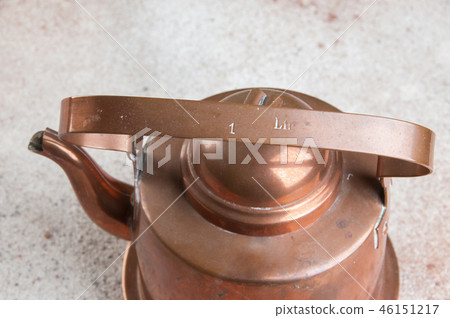 Vintage copper kettle on concrete background. Vintage copper kettle on concrete background. 46151217