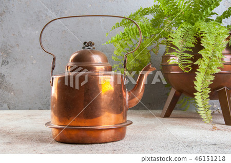 Vintage copper kettle on concrete background. 46151218