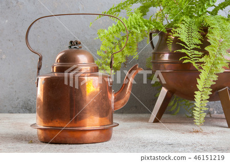 Vintage copper kettle on concrete background. 46151219