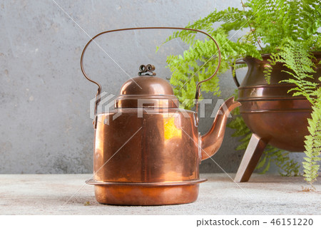 Vintage copper kettle on concrete background. Vintage copper kettle on concrete background. 46151220