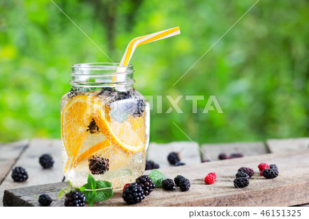 Cocktail lemonade from orange and berries in mason jar Cocktail lemonade from orange and berries in mason jar 46151325