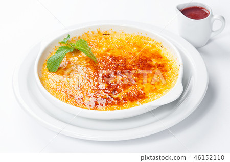 French dessert creme brulee with berry sauce  46152110