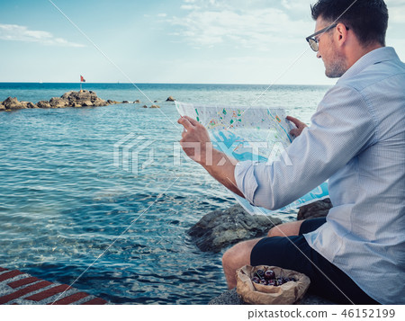 Stylish man, holding a tourist map in his hands 46152199