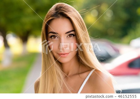 Closeup portrait, girl with long hair and tanned skin. Emotionally staring. Clean skin is a natural 46152555