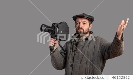 Emotional cameraman with retro camera, studio shot 46152832