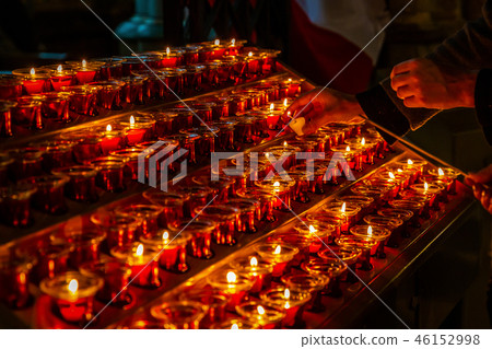 Beewax candles lighting up by prayers Beewax candles lighting up by prayers 46152998