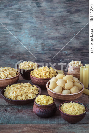 Various types of pasta on the white background 46155286