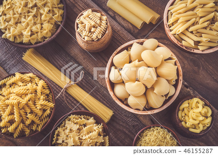 Various types of pasta on the white background 46155287