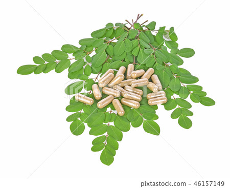 Herbal capsules with leaf  on white background 46157149
