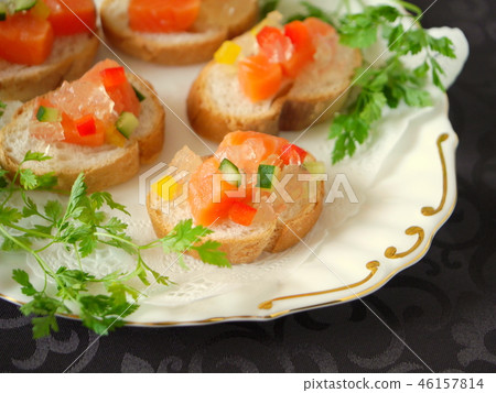 Baguette canape with salmon and conso méjé black background (up) 46157814
