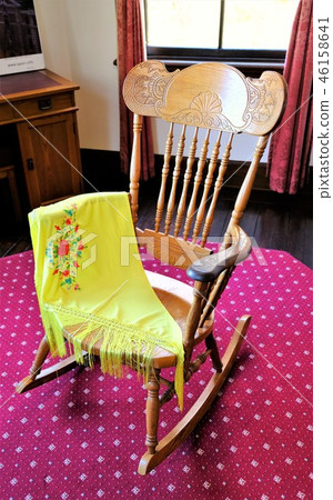 Yellow throw and rocking chair Yellow throw and rocking chair 46158641