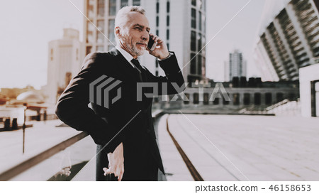 Businessman is Talking on Mobile Phone Businessman is Talking on Mobile Phone 46158653