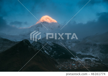 Stepantsminda, Georgia. Mount Kazbek In Morning Sunlit And Famou Stepantsminda, Georgia. Mount Kazbek In Morning Sunlit And Famou 46161774