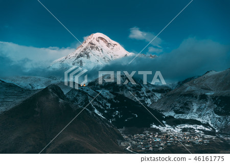 Stepantsminda, Georgia. Peak Of Mount Kazbek Covered With Snow A Stepantsminda, Georgia. Peak Of Mount Kazbek Covered With Snow A 46161775