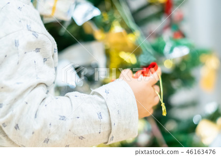 Christmas image Children decorating a Christmas tree 46163476