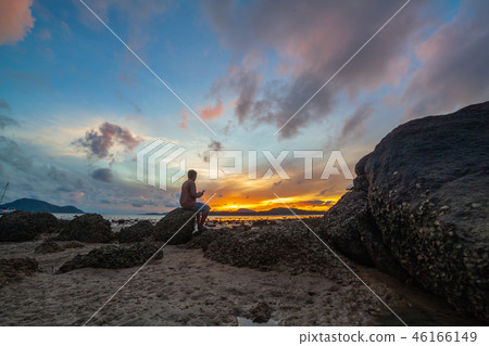 a man selfie on the rock at sunrise a man selfie on the rock at sunrise 46166149