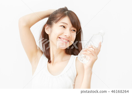 A woman holding a bottle of mineral water in a hot spring A woman holding a bottle of mineral water in a hot spring 46168264