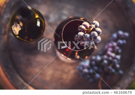 A glass of wine and a bottle of red wine A glass of wine and a bottle of red wine 46168679
