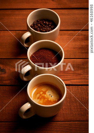 Three cups of espresso on a wooden table 46168998