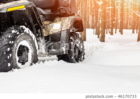 Close-up ATV 4wd quad bike in forest at winter. 4wd all-terreain vehicle stand in heavy snow with 46170733