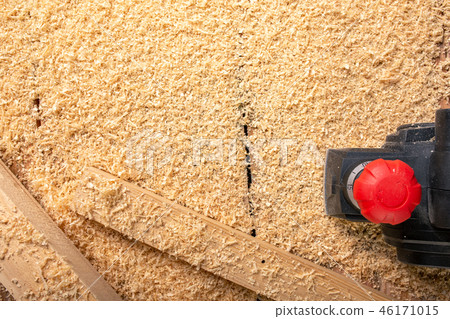 the electric sander on a wood backgroundshavings 46171015