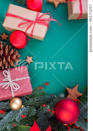 Christmas composition. Christmas green decorations, fir tree branches with toys gift boxes on green 46171057