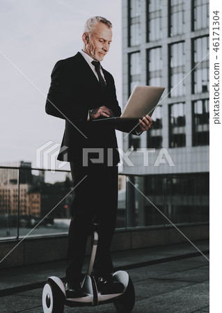 Man is Using a Laptop on Gyroboard 46171304