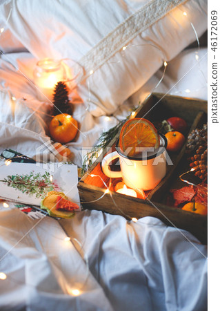 Christmas background dry oranges, sweet tangerines in a box, coffee in a white mug. 46172069