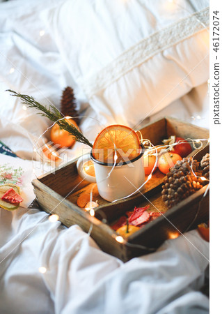 Christmas background dry oranges, sweet tangerines in a box, coffee in a white mug. Christmas background dry oranges, sweet tangerines in a box, coffee in a white mug. 46172074