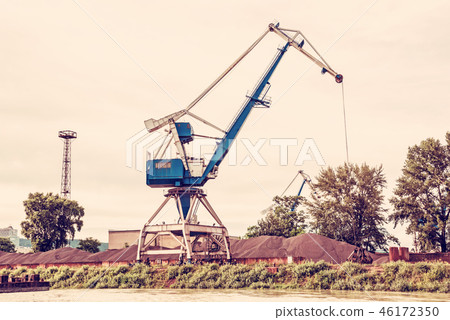 Blue crane in cargo port, red filter 46172350
