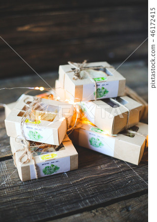 Christmas - a group of gifts on the background of garlands. close-up Christmas - a group of gifts on the background of garlands. close-up 46172415