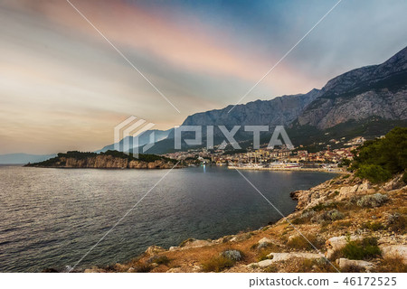 Makarska, Croatia. View of the beach and the old town at sunset 46172525