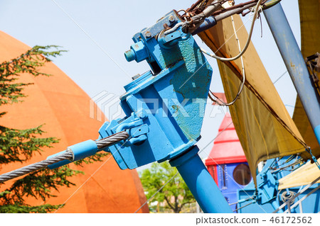 a steel pedestrian bridge tenso structure with support poles and tie-rods on a sunny day with a blue 46172562