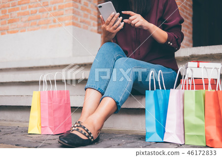 Consumerism, shopping, lifestyle concept, Young woman sitting ne Consumerism, shopping, lifestyle concept, Young woman sitting ne 46172833